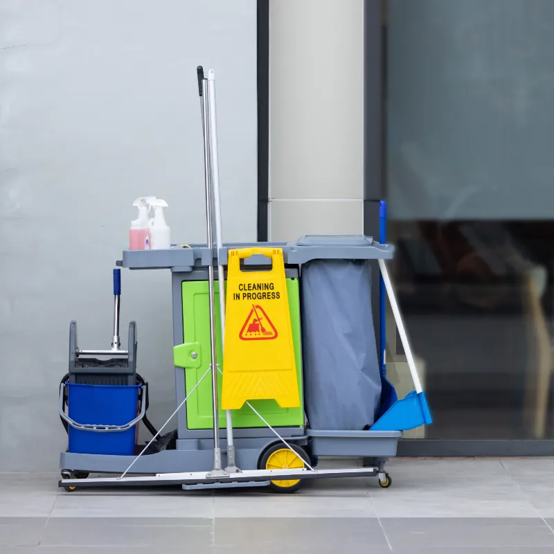 A cleaning cart with a "Cleaning in Progress" sign