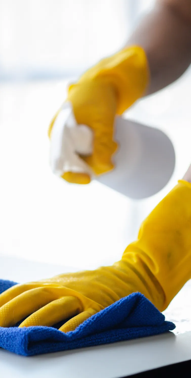 A cleaner wiping an office desk
